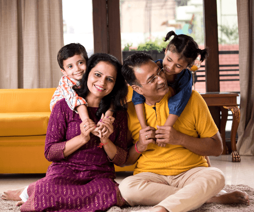 A family sitting together at home, smiling
